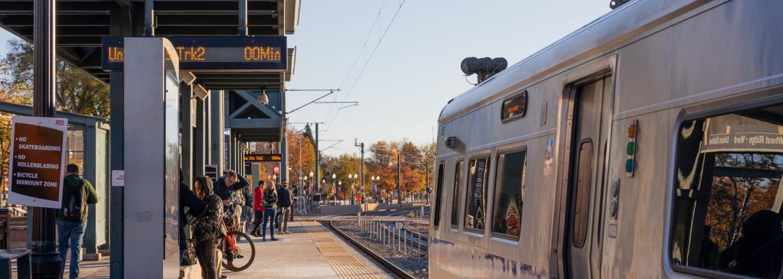 People waiting for the G-line commuter rail on the station platform in Olde Town Arvada.